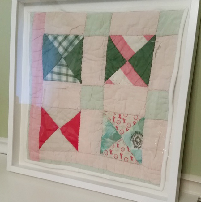 damaged quilt preserved in shadowbox