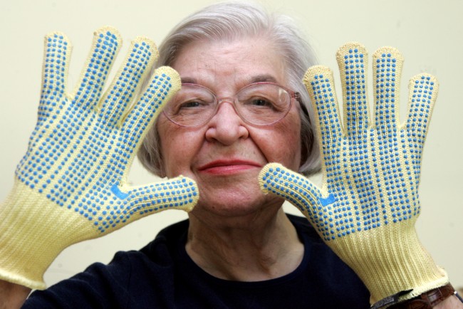 FILE - Stephanie Kwolek, 83, shown in this June 20, 2007 file photo taken in Brandywine Hundred, Del.,  she wears regular house gloves made with the Kevlar she invented. Her friend, Rita Vasta, told The Associated Press that Stephanie Kwolek died Wednesday in a Wilmington hospital. at age 90. (AP Photo/The News Journal, Jennifer Corbett)