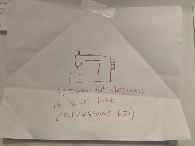 a hand drawing by a small child of a sewing machine with the words "All I want for Christmas ifs your love...and Christas PJs"